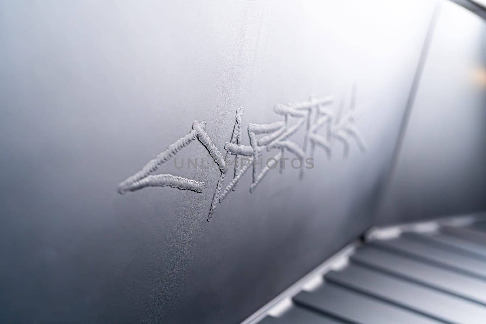 Denver, Colorado, USA-May 5, 2024-This image captures the intricate engraved Tesla logo located inside the open frunk of a Tesla Cybertruck, showcasing the attention to detail and sleek design elements characteristic of Tesla innovative electric vehicles.