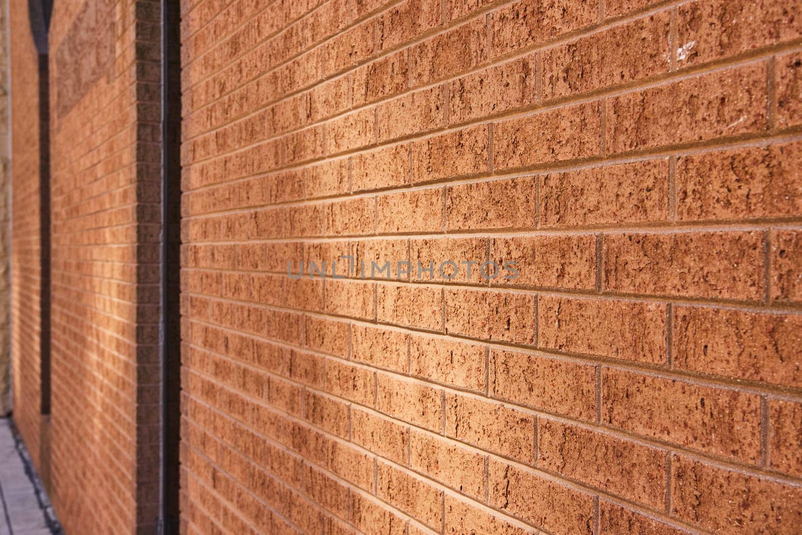 Close-up of a textured brick wall in downtown Fort Wayne, Indiana, showcasing architectural detail and craftsmanship.