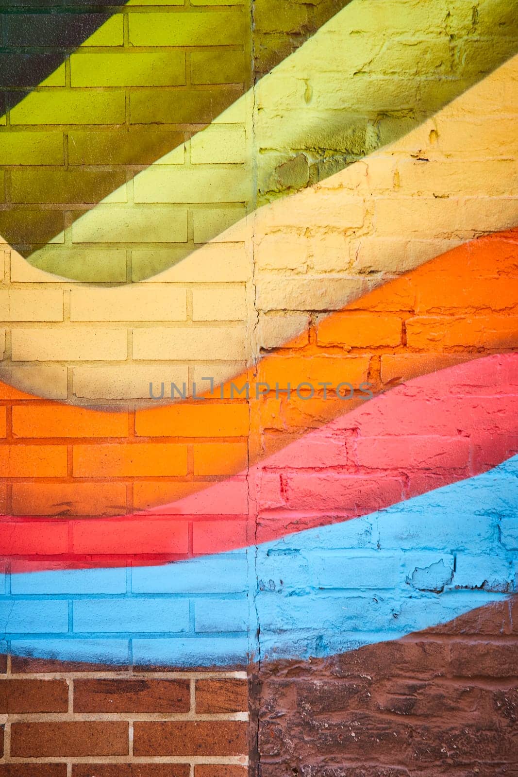 Vibrant street art mural on a brick wall in downtown Fort Wayne, Indiana, showcasing dynamic urban culture.