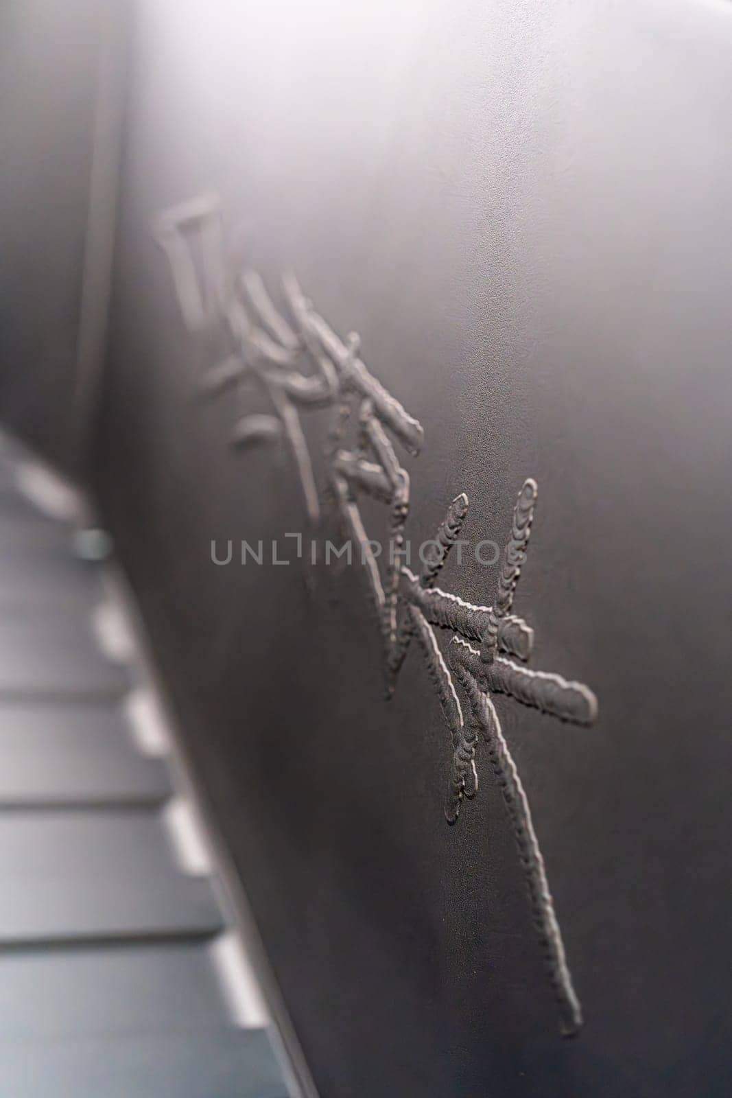 Denver, Colorado, USA-May 5, 2024-This image captures the intricate engraved Tesla logo located inside the open frunk of a Tesla Cybertruck, showcasing the attention to detail and sleek design elements characteristic of Tesla innovative electric vehicles.