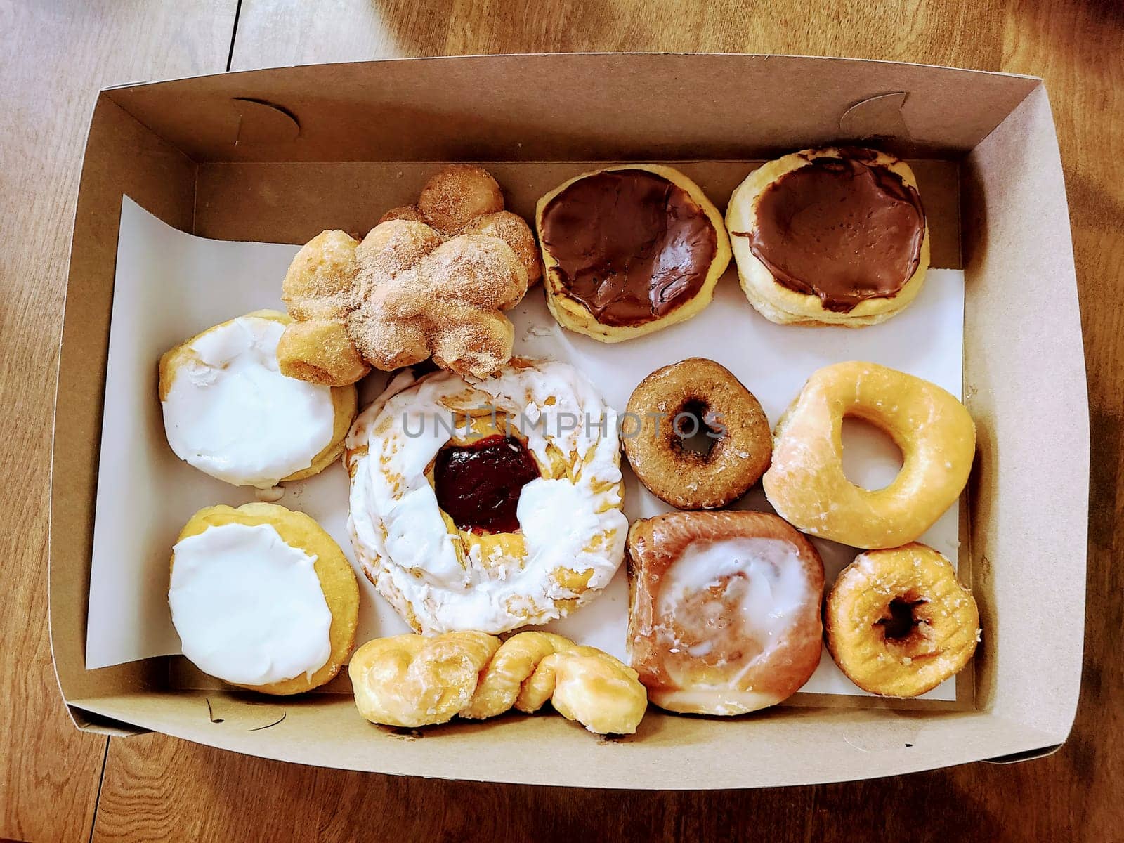 Assorted fresh doughnuts in a box, from glazed to chocolate-covered, perfect for any sweet treat occasion in Indianapolis.