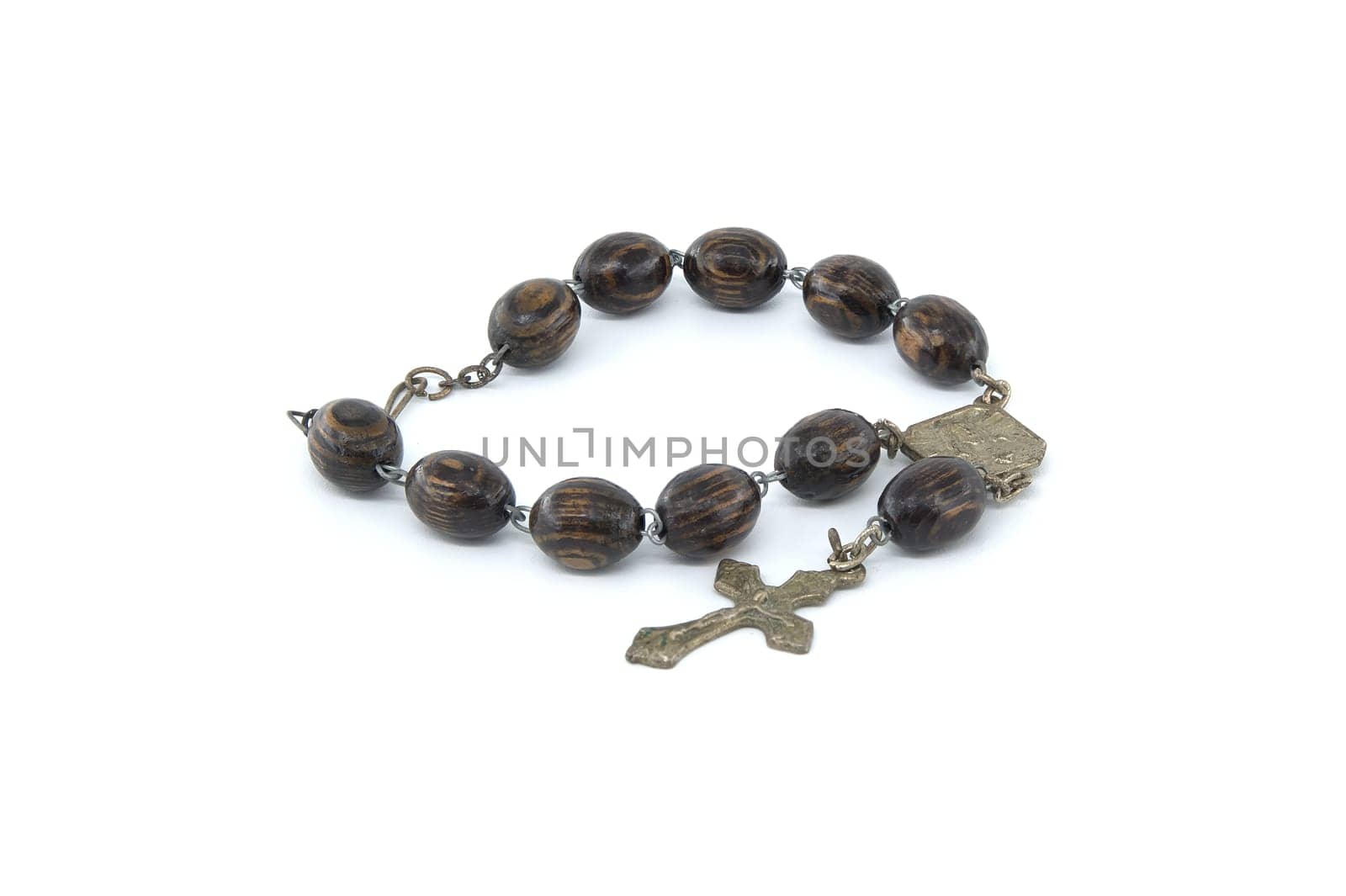 Rosary with wooden beads and a crucifix isolated on white background