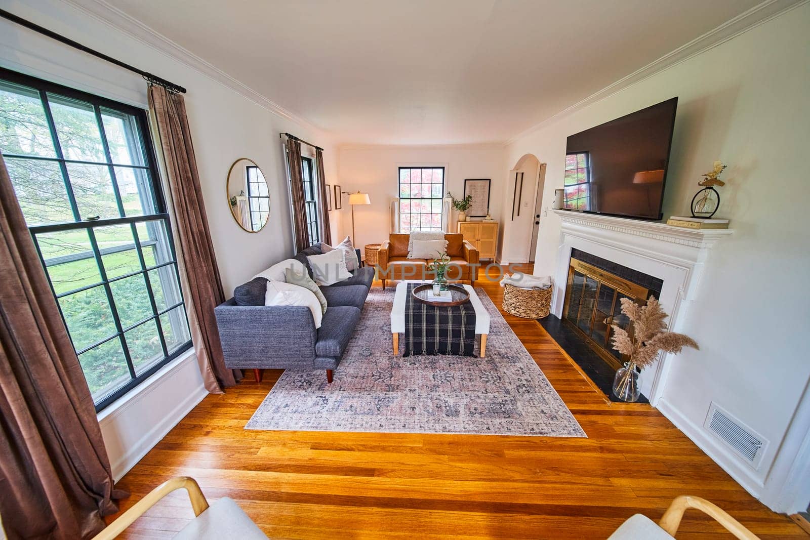 Spacious, sunlit living room blending modern and classic design in Fort Wayne home.