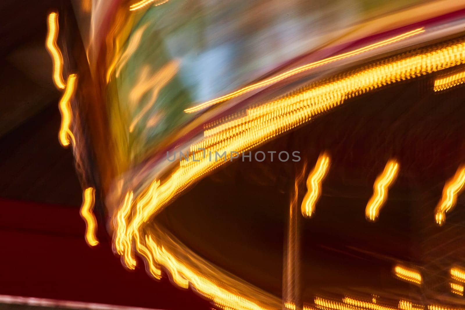 Vibrant long exposure of a carousel in motion at Fort Wayne Children's Zoo, capturing the thrill and colors of nightlife.