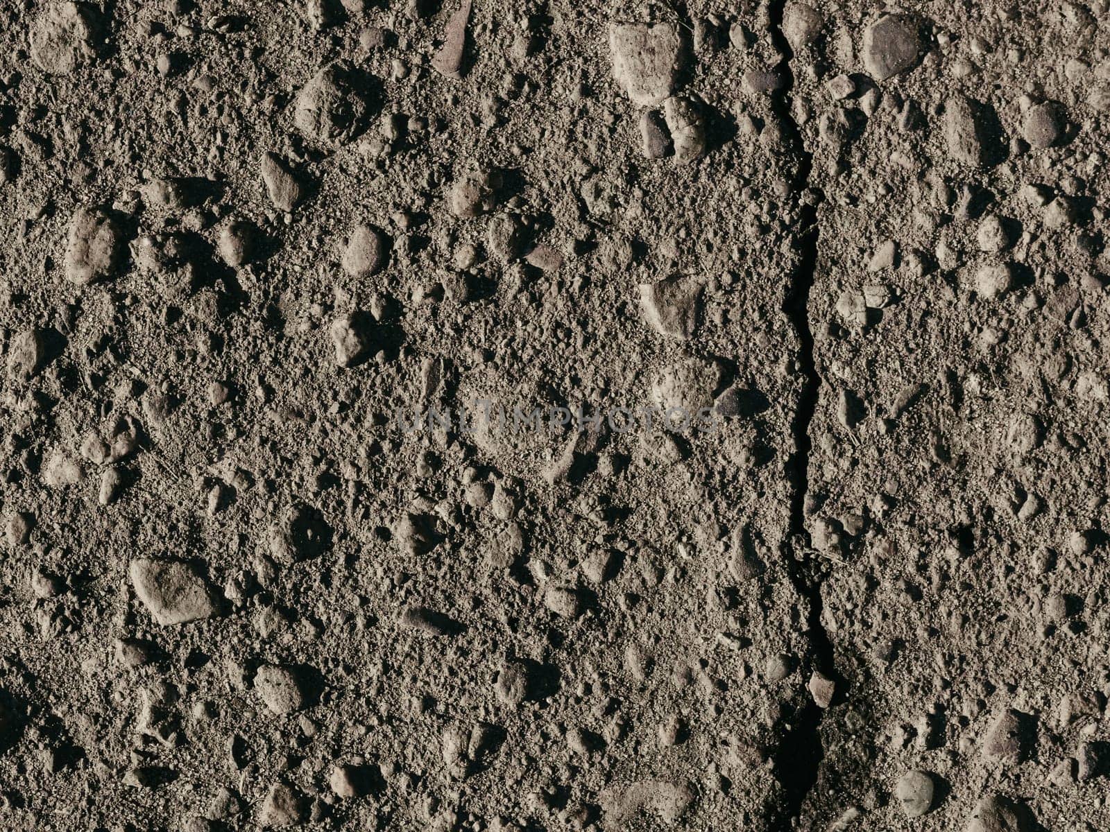 texture of dirty old asphalt with stones close-up
