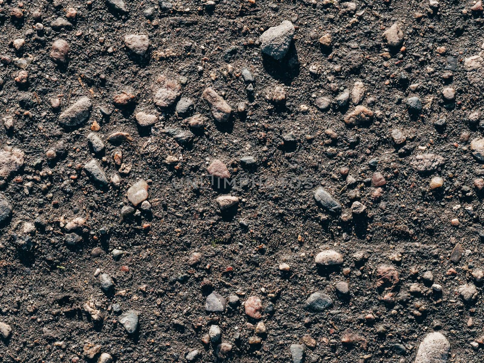 texture of dirty old asphalt with stones close-up