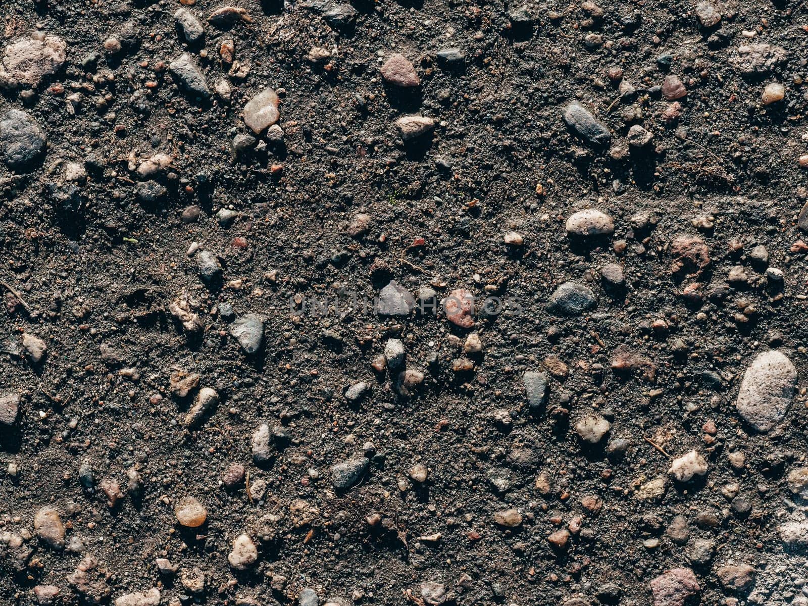 texture of dirty old asphalt with stones close-up