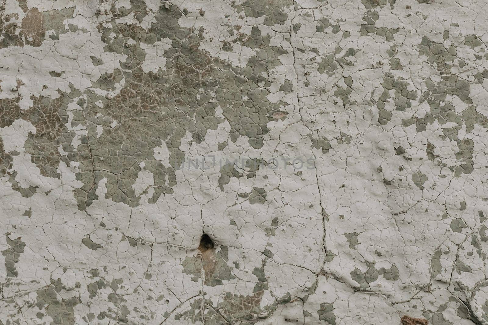 old concrete wall with cracks and peeling paint. Vintage style texture