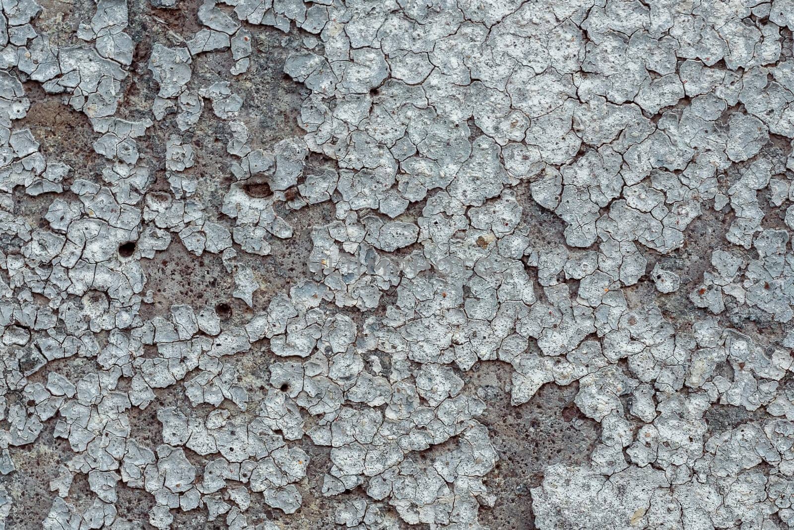 old concrete wall with cracks and peeling paint. Vintage style texture
