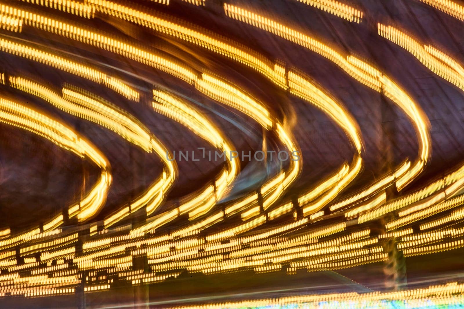 Golden light arcs sweep through the night at Fort Wayne Children's Zoo, capturing movement and energy.