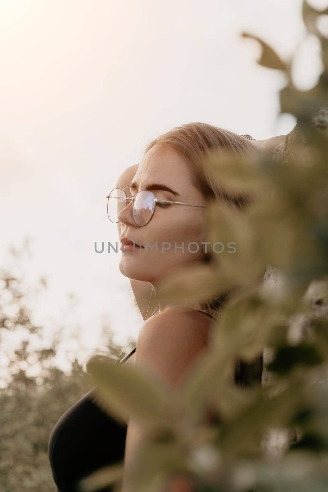 Woman summer travel. Happy tourist enjoy taking selfie photo outdoors for memories. Woman traveler posing in summer park on sunset, sharing travel adventure journey by panophotograph