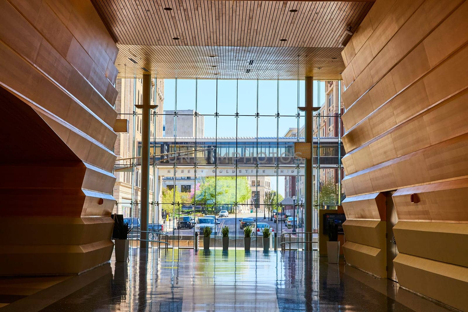 Elegant grand staircase in a modern public space with sweeping wooden architecture and urban views, Fort Wayne.