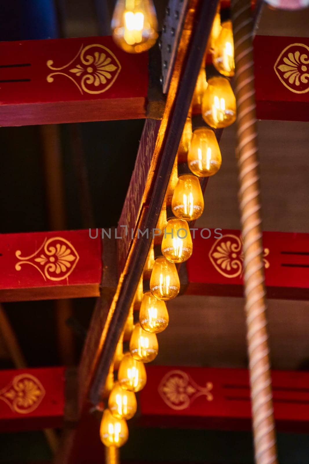Close-up of a vibrant red and gold carousel at Fort Wayne Children's Zoo, Indiana, glowing with warmth and nostalgia.