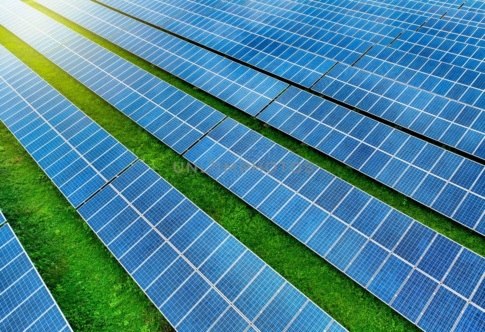 Solar farm and sun light. Solar power for green energy. Sustainable renewable energy. Photovoltaic power station or solar park. Solar panel installation and maintenance concept. Energy sustainability.