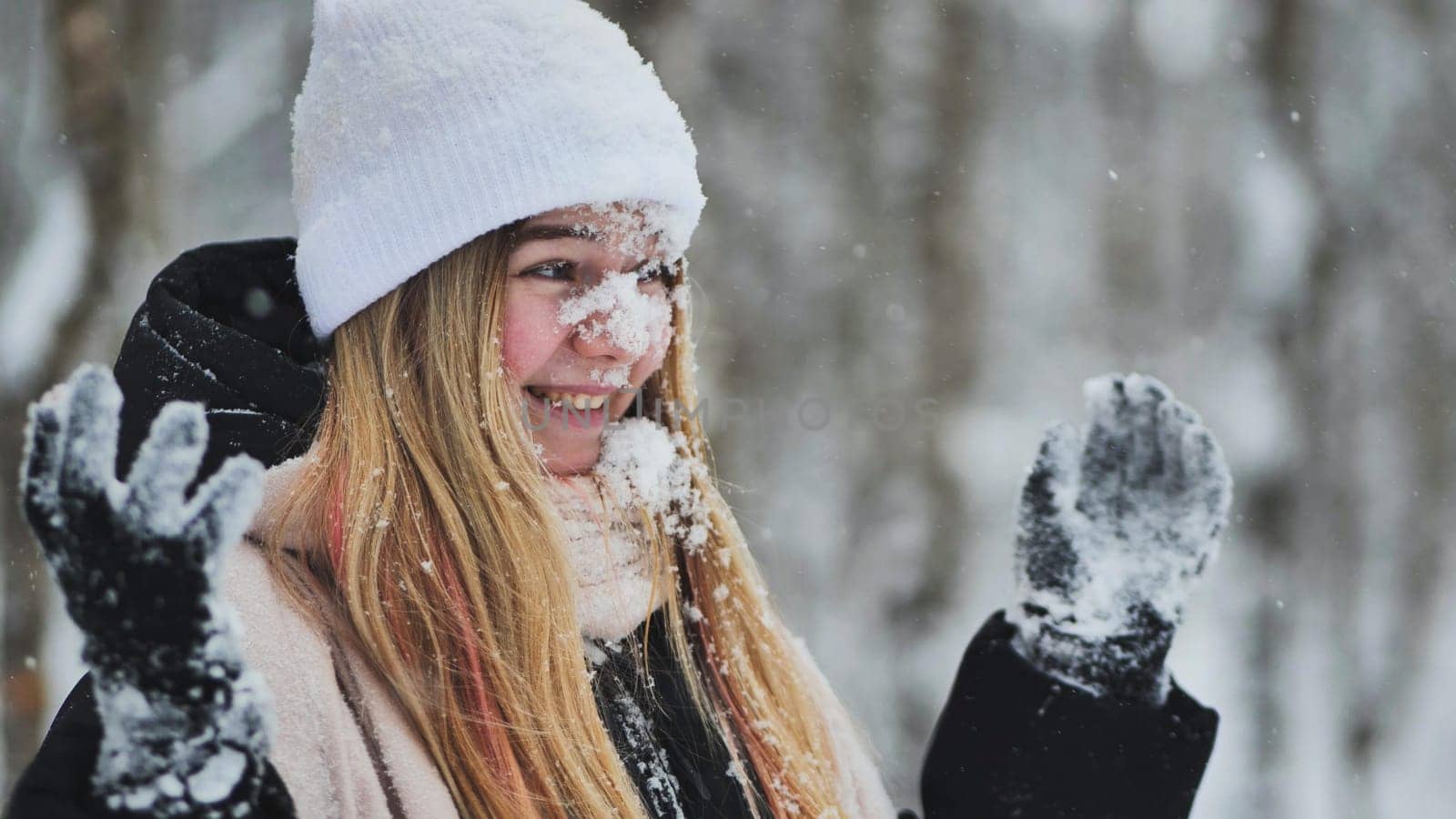 Teenage girl playing with snow