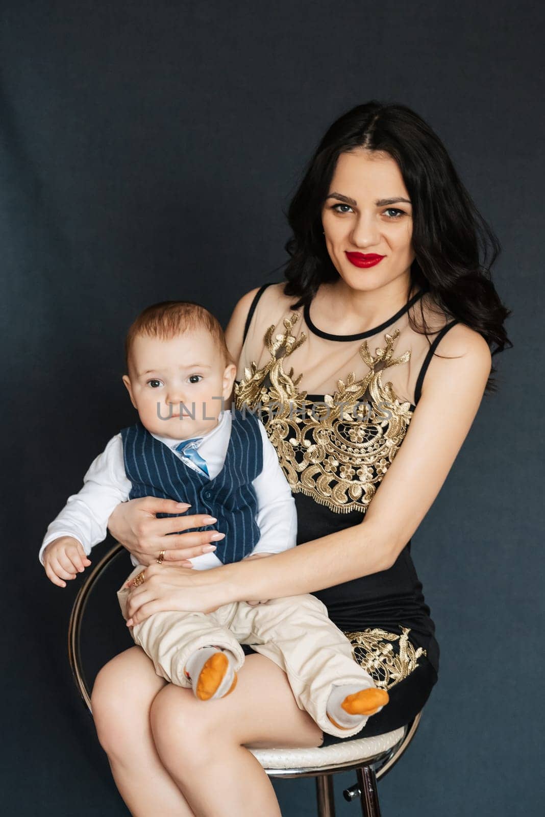young attractive mom the girl and the boy child son in the Studio. Happy healthy Caucasian family