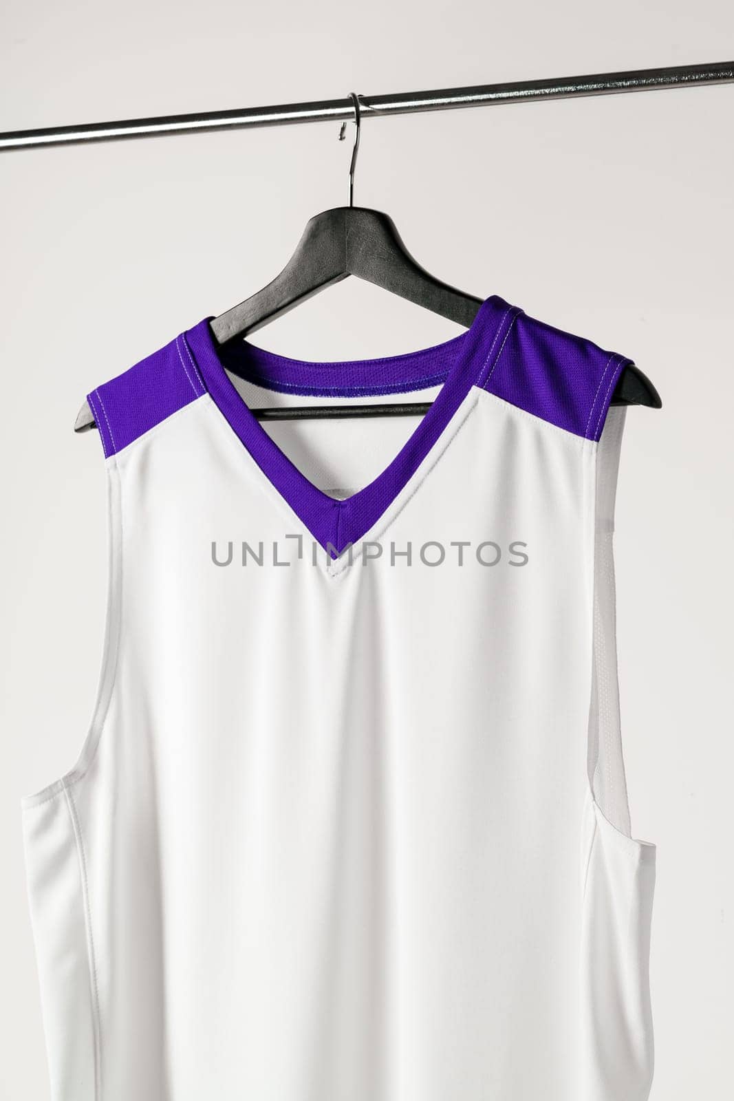 White basketball jersey hanging against white background by Fabrikasimf