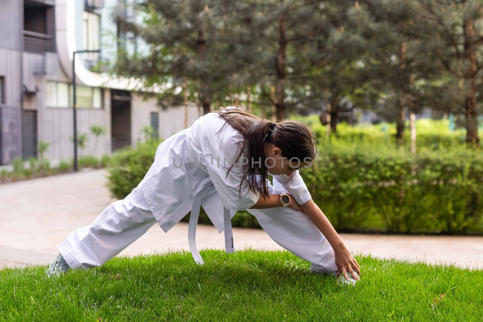 young girl in a white kimono, karate. High quality photo