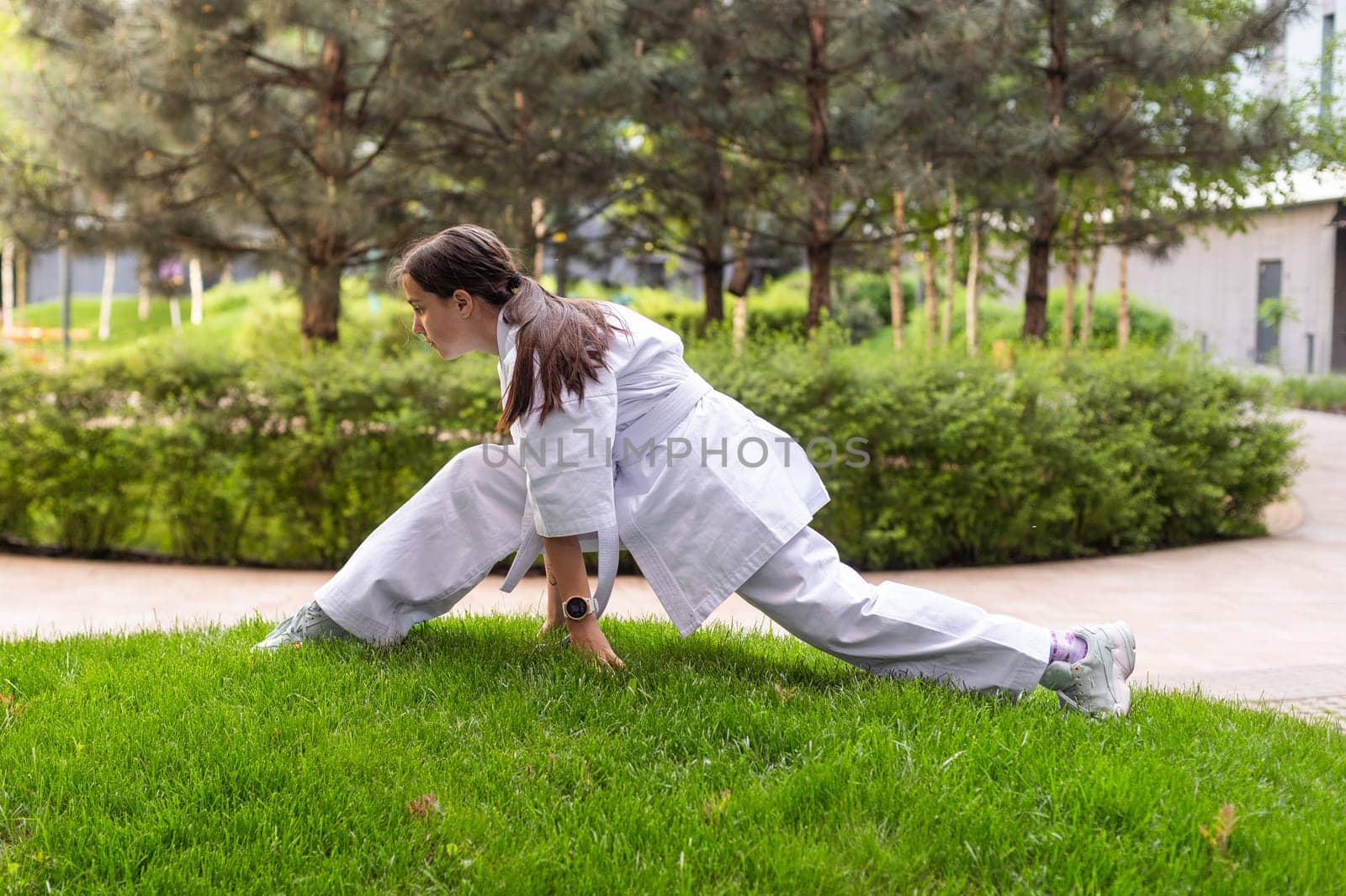 Karate, teenager girl in kimono training. High quality photo