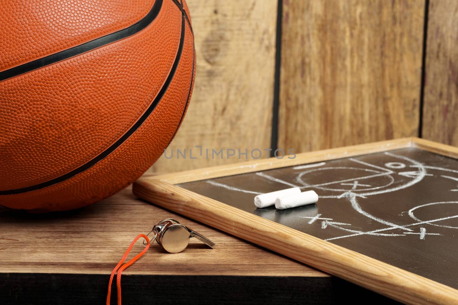 Basketball ball lying on a wooden floor close up