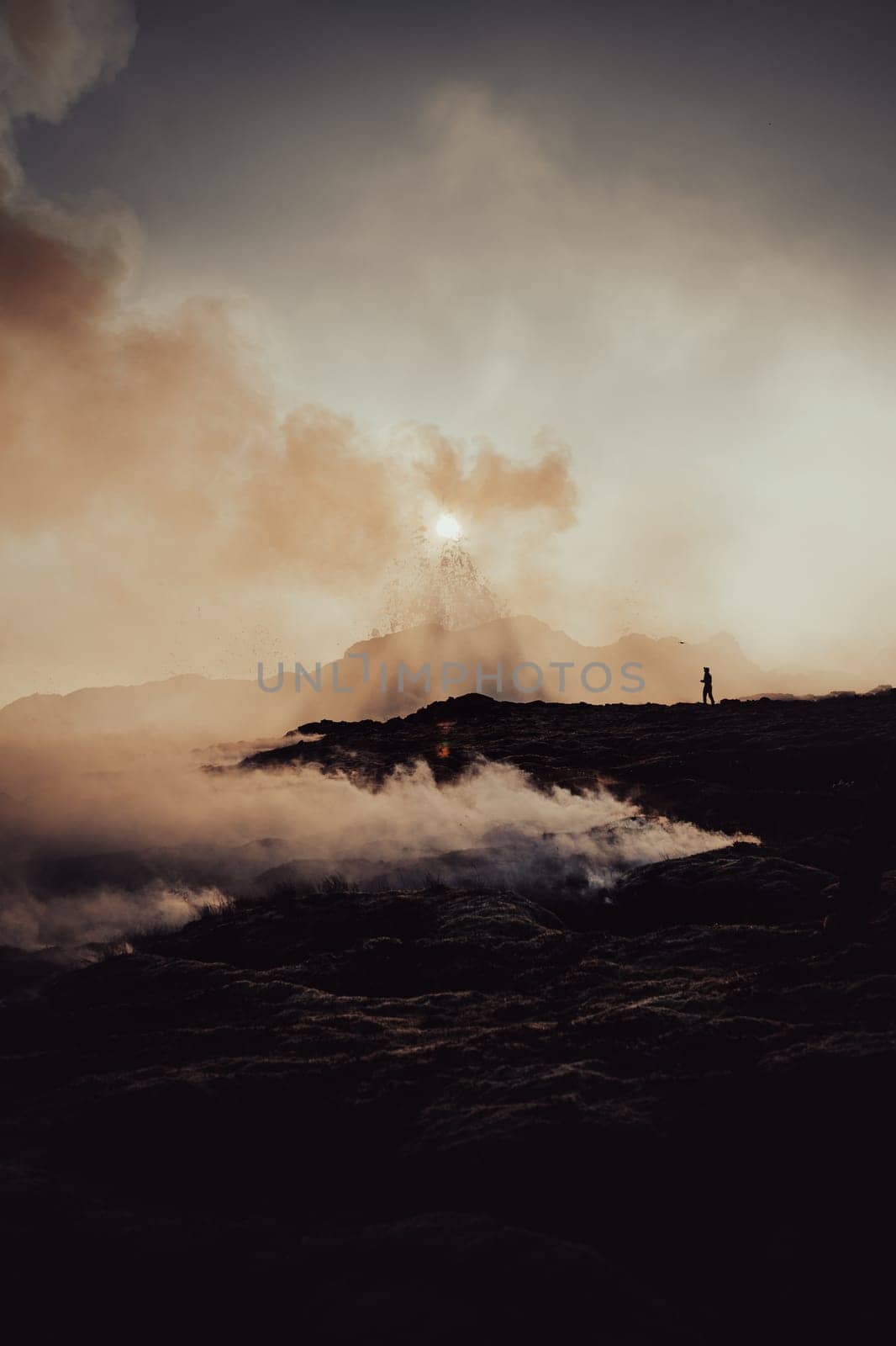 A drone pilot next to the volcano with spattering of boiling erupting molten lava. by Kustov