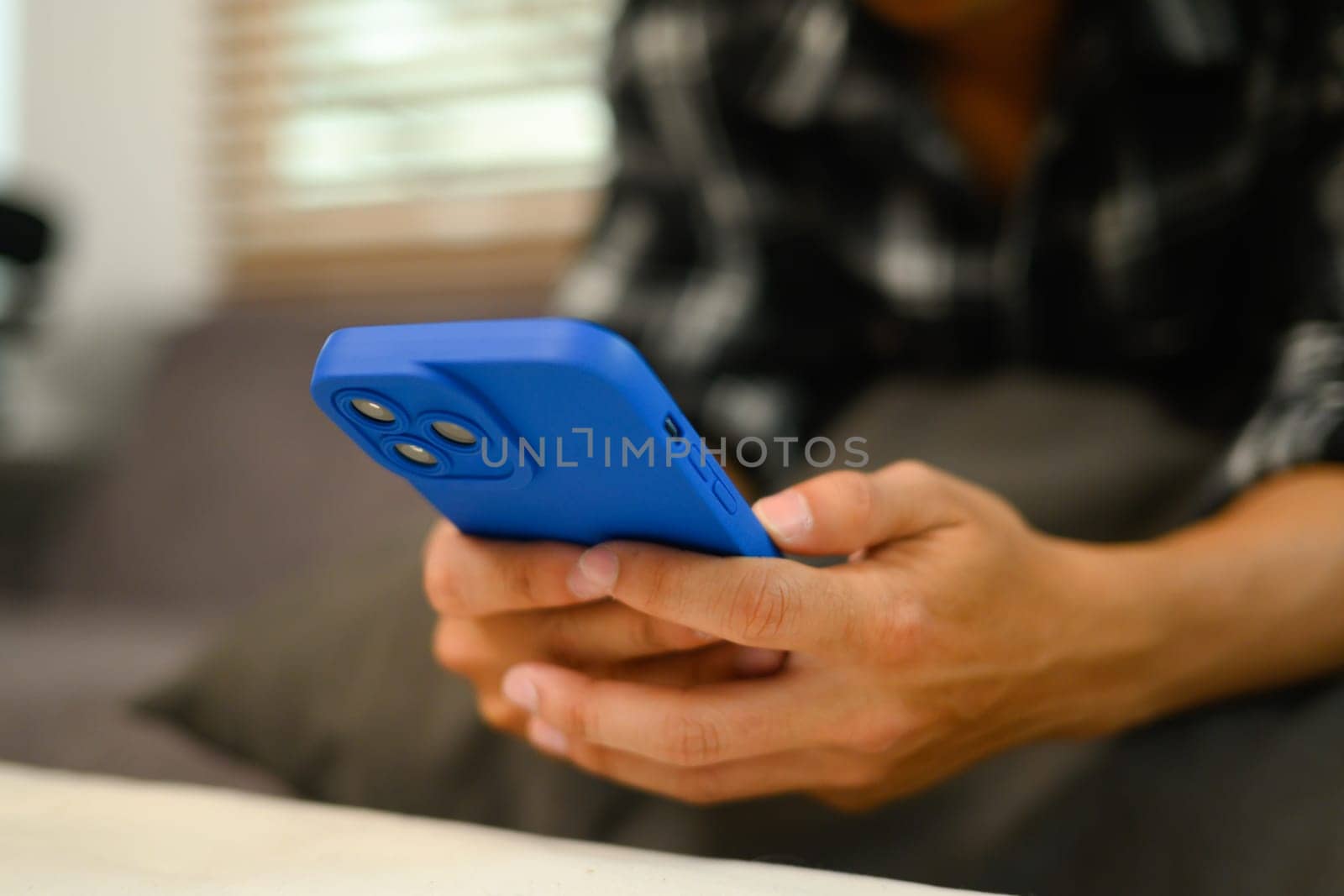 Closeup image of man reading text message and chatting in mobile application by prathanchorruangsak