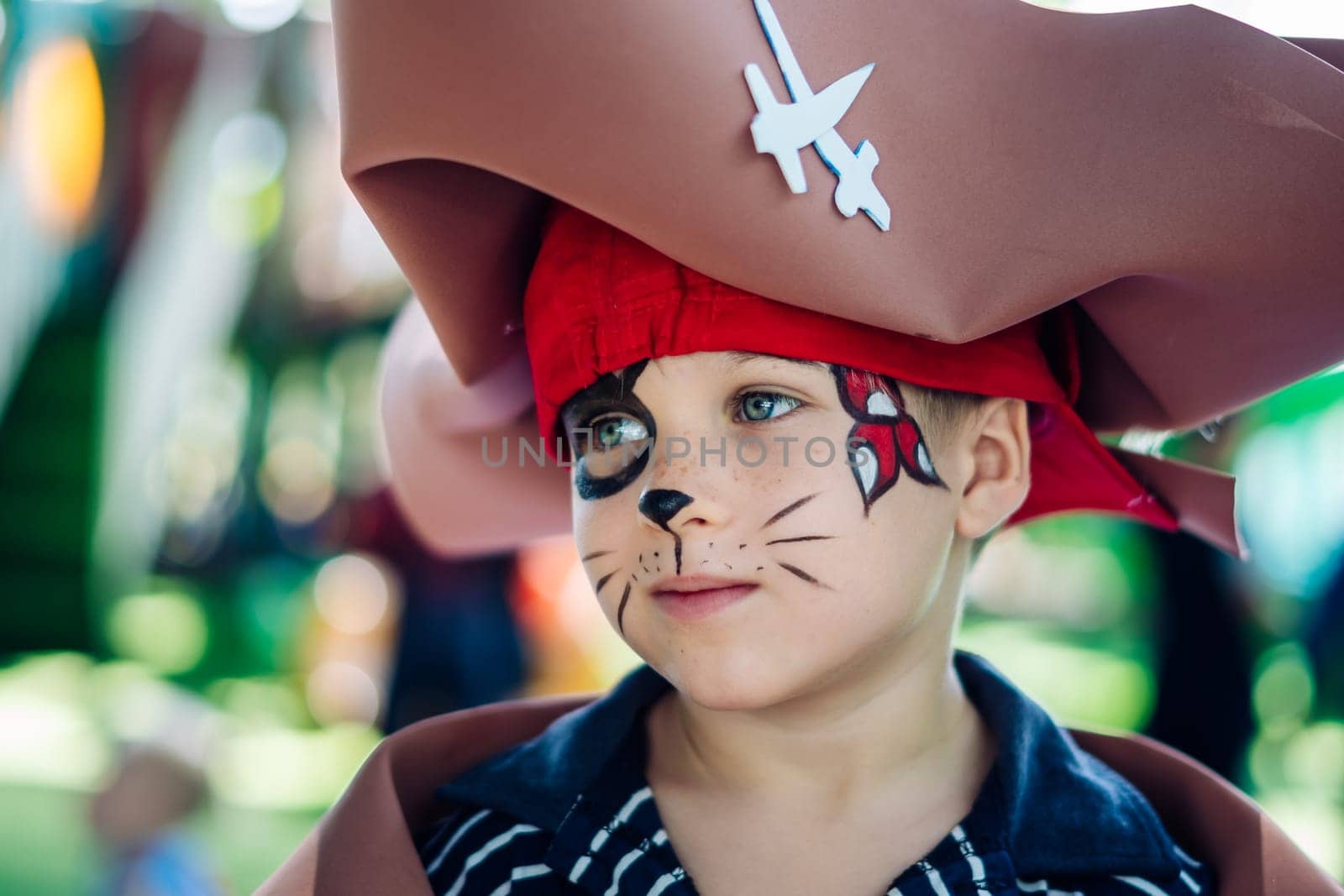 Boy Cat Pirate costume. Halloween party in kindergarten. Aqua makeup painted kids face. Bright festive.