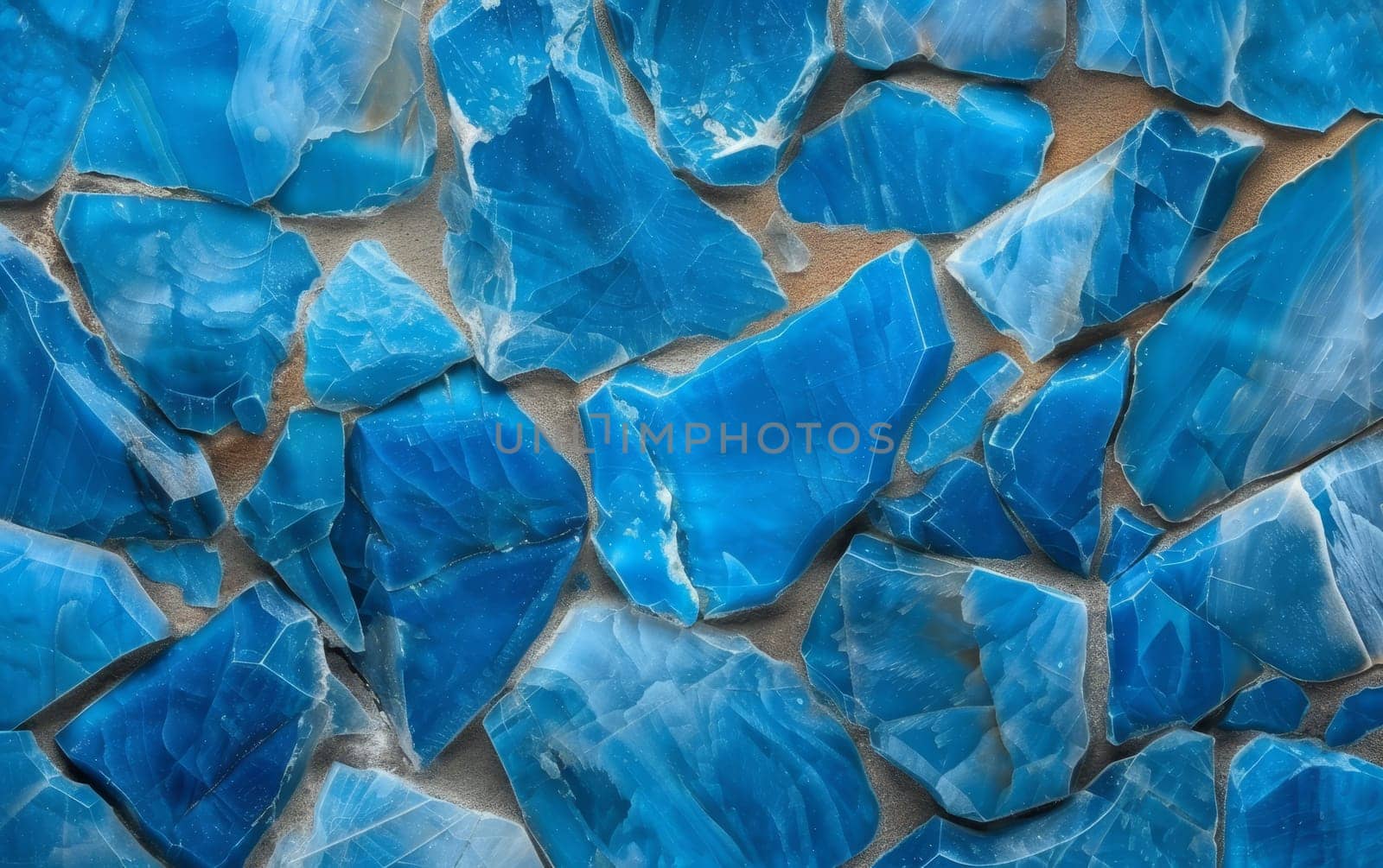 Close-up view of a wall made of irregularly shaped stones in various shades of blue