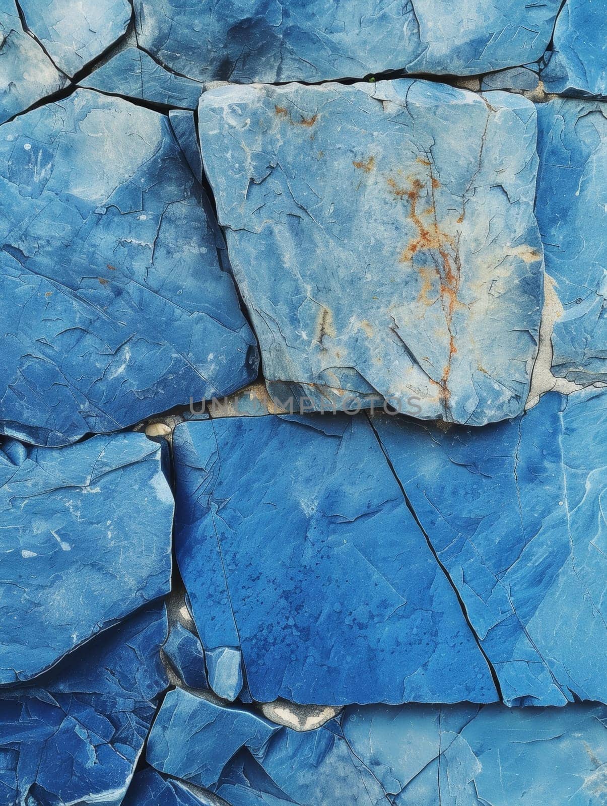 Close-up view of a surface covered with various shapes and sizes of stones embedded in it