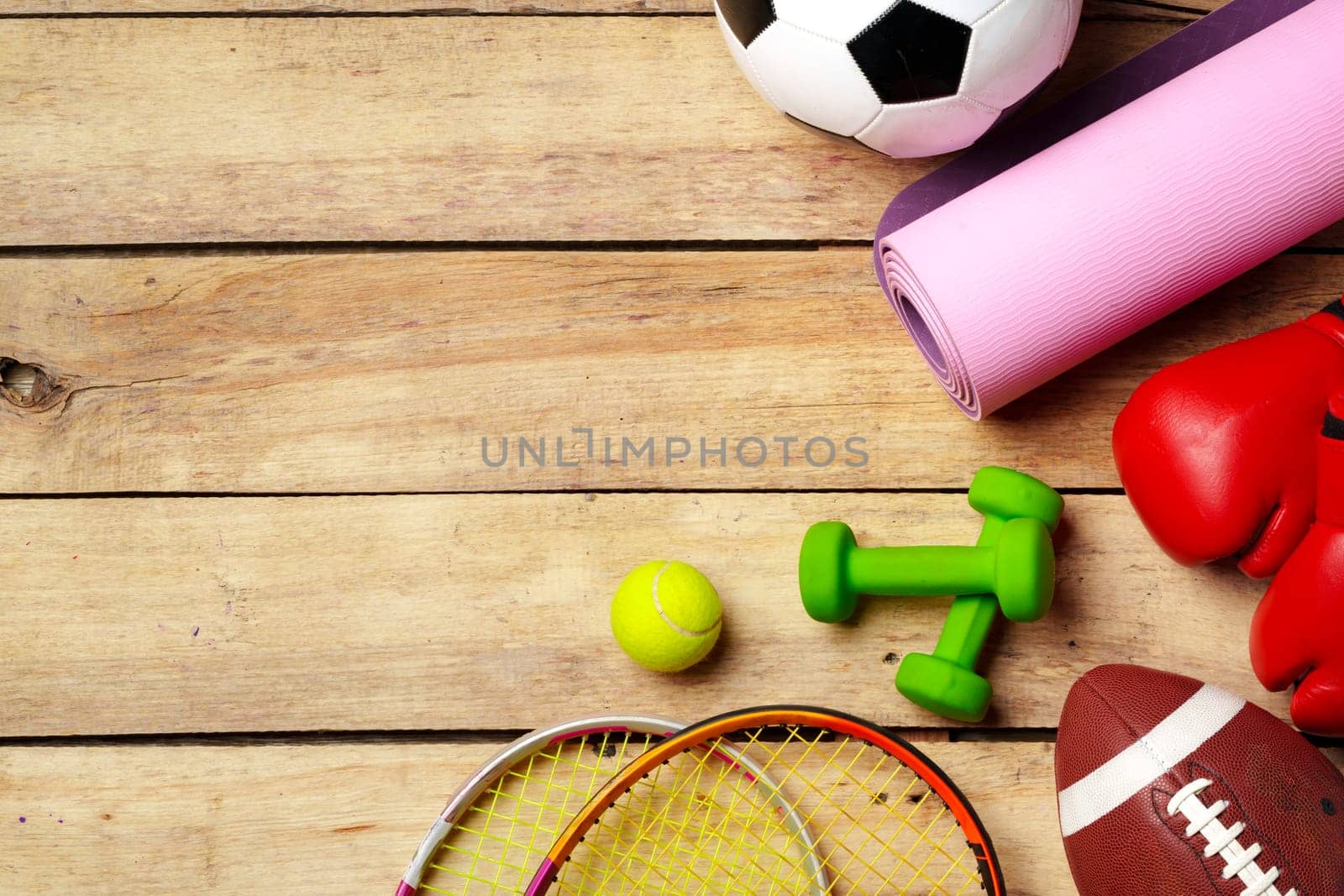 Different sports equipment on wooden background top view photo