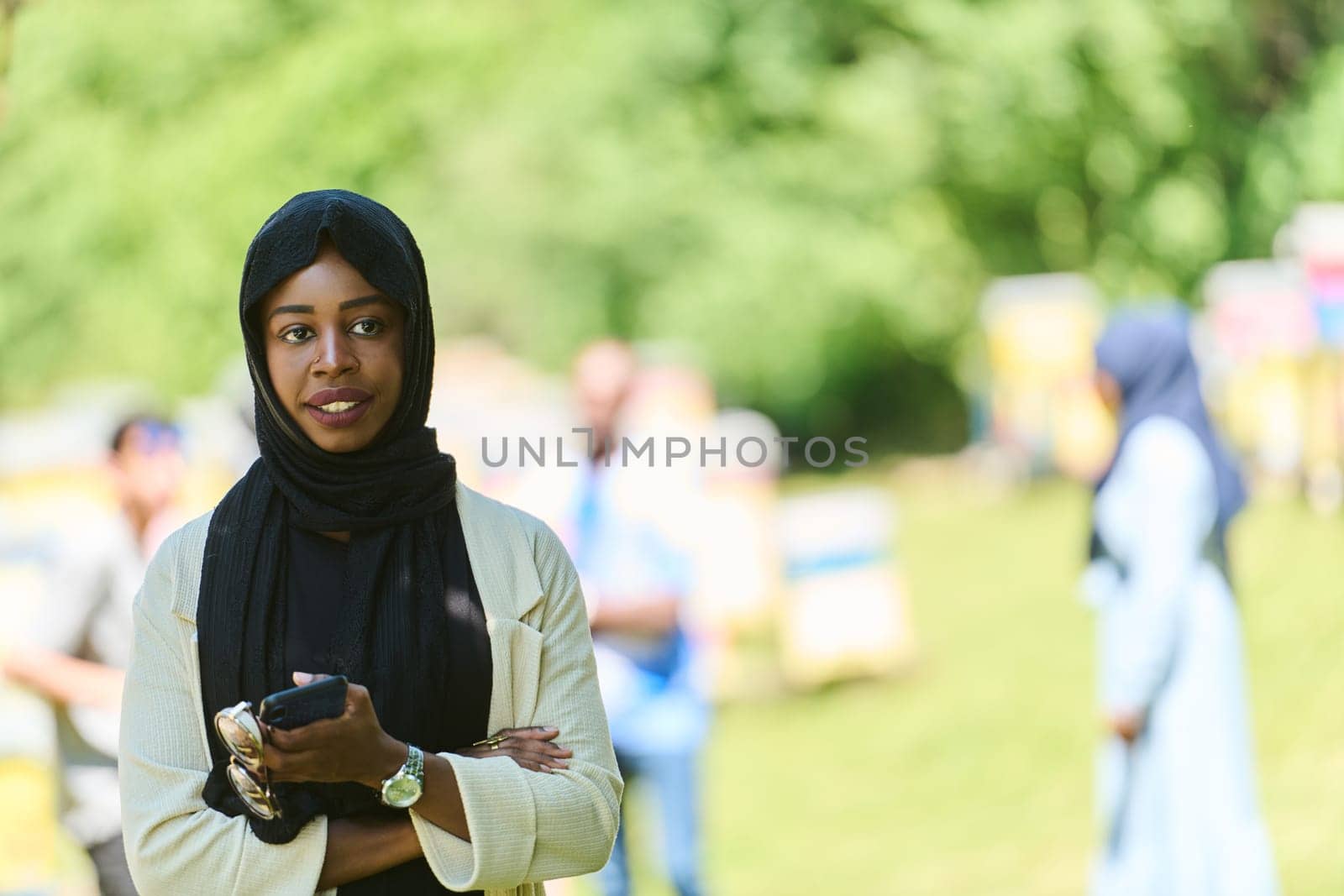 Middle Eastern Muslim woman in a hijab uses a smartphone while managing a small beekeeping business, blending modern technology with traditional practices