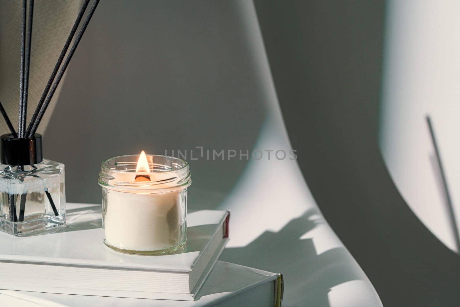 Aromatic candle in glass jar close up by Fabrikasimf