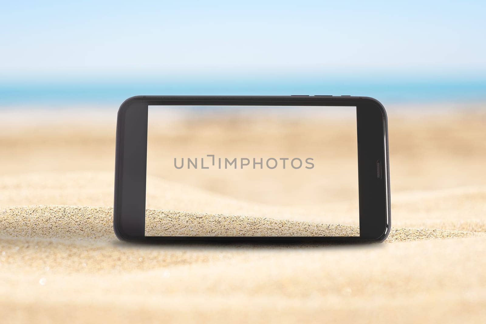 Mobile phone screen on the sandy beach with blue sea background by Annavish