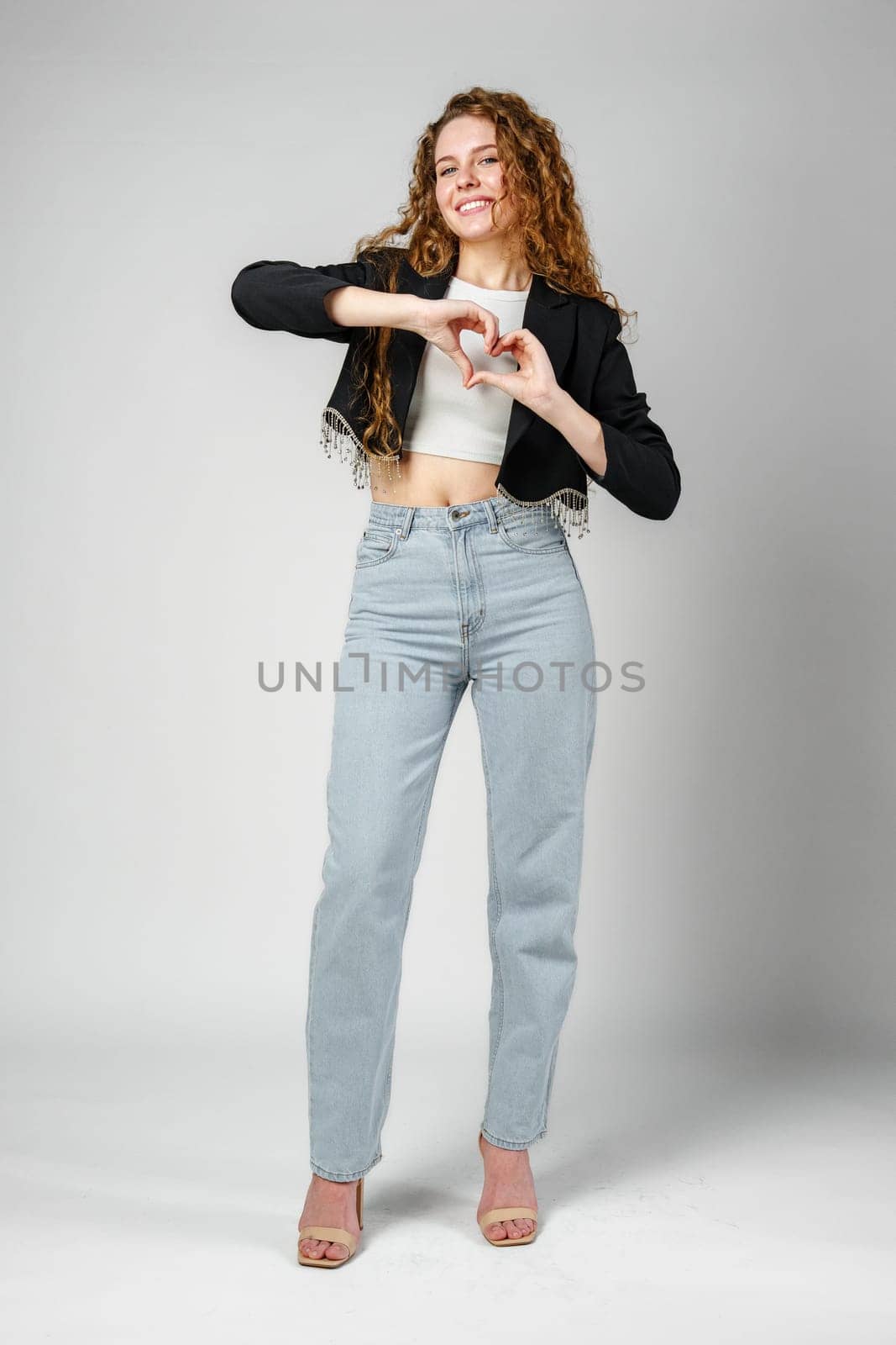 Woman Making Heart With Hands in Studio close up