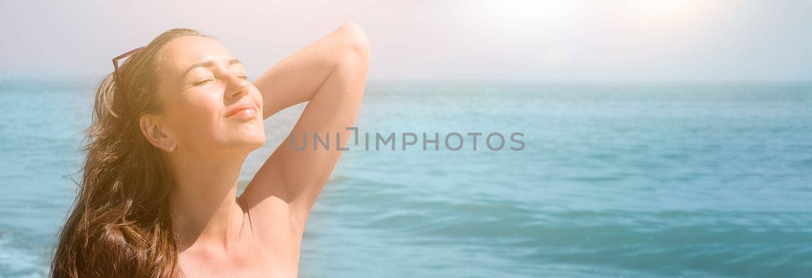 Happy beautiful young woman relaxing at the beach side, girl enjoying sunny day out, healthy summer lifestyle concept. Banner