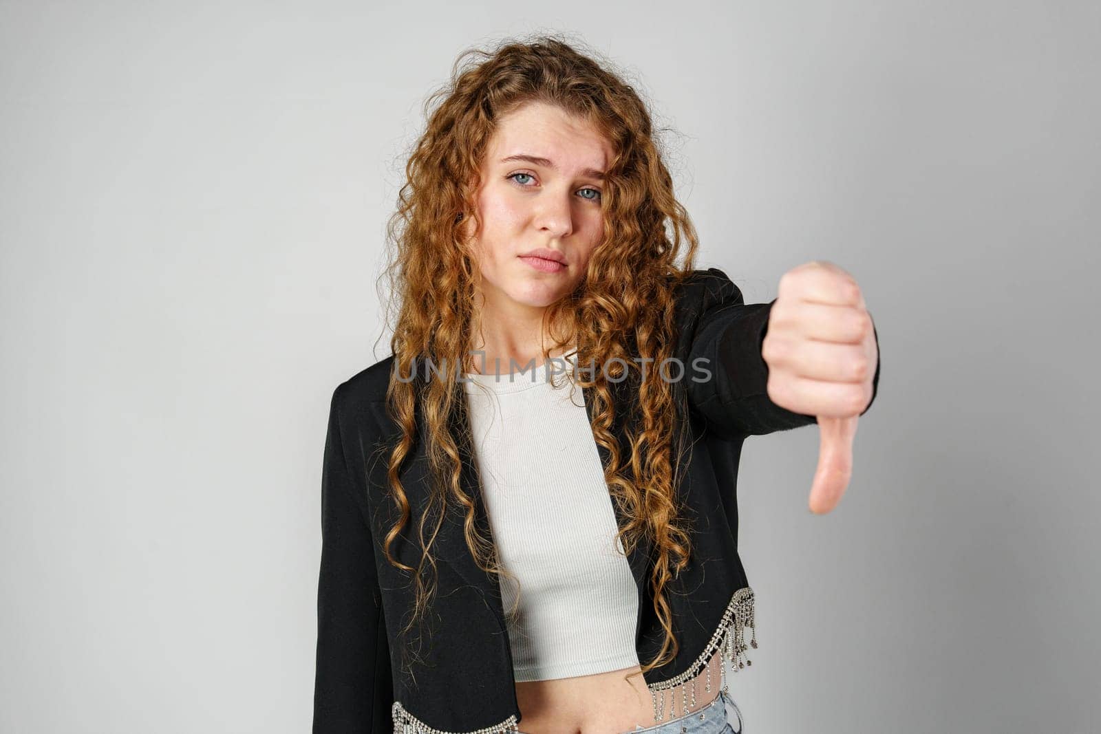 Woman With Curly Hair Giving a Thumbs Down by Fabrikasimf