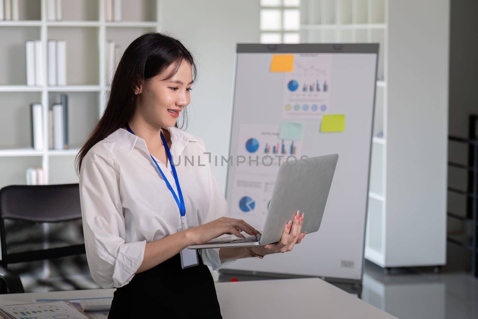 Asian Businesswoman Using Laptop in Office Presentation by nateemee