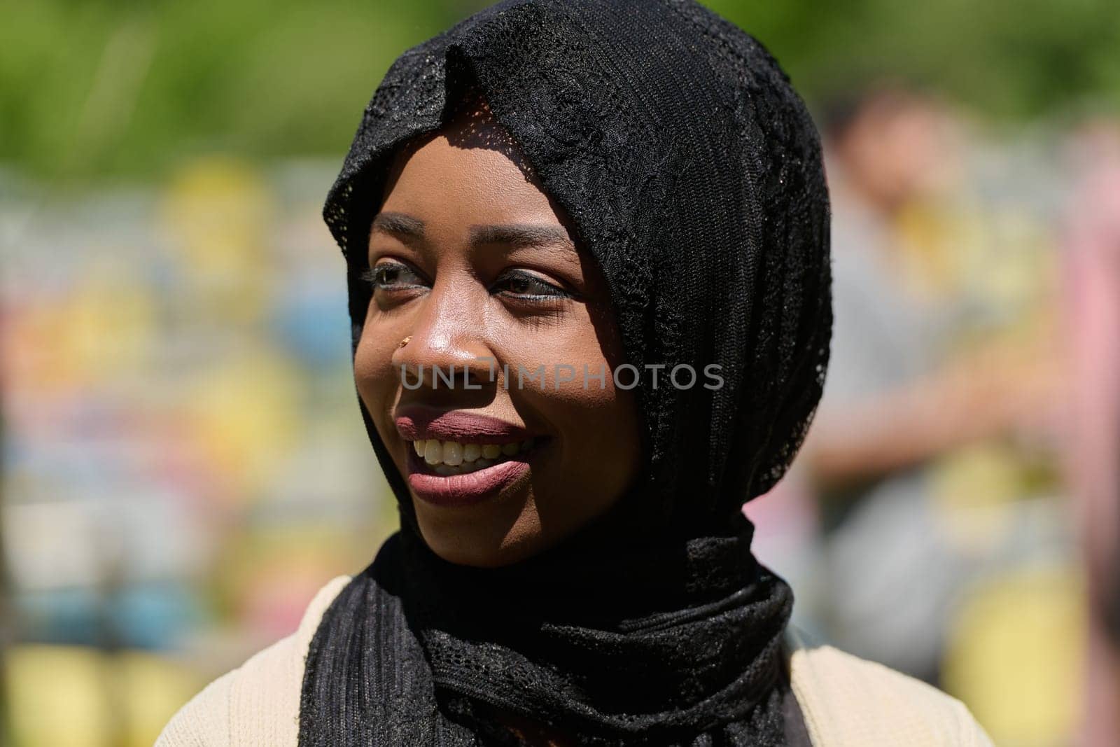 Joyful Middle Eastern Muslim Woman in Hijab Smiling Brightly in a Natural Apiary by dotshock