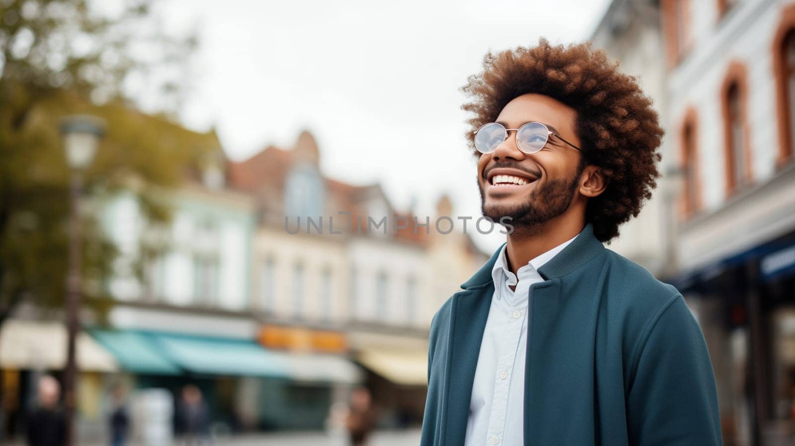 Confident happy smiling black entrepreneur standing in the city, wearing glasses and looking away by Rohappy