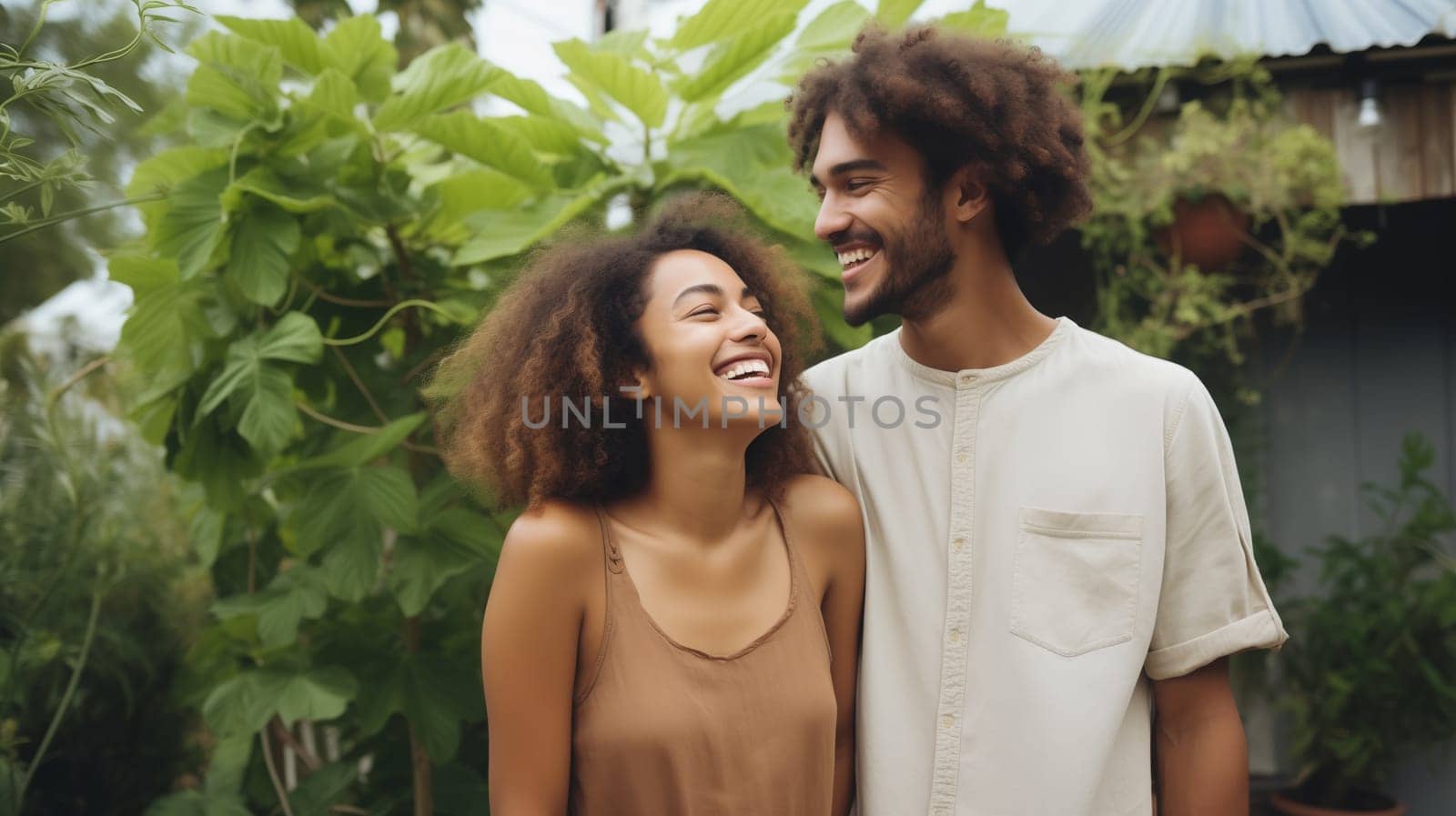 Portrait happy smiling multiethnic young couple owners in summer backyard of their own country house by Rohappy