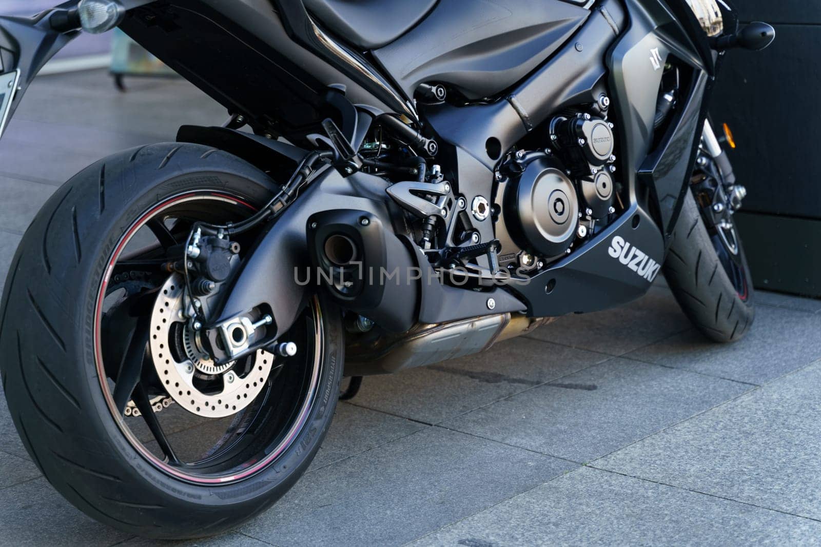 Wroclaw, Poland - August 4, 2023: A black Suzuki GSX motorcycle is parked in front of a building, showcasing its sleek design and powerful presence.