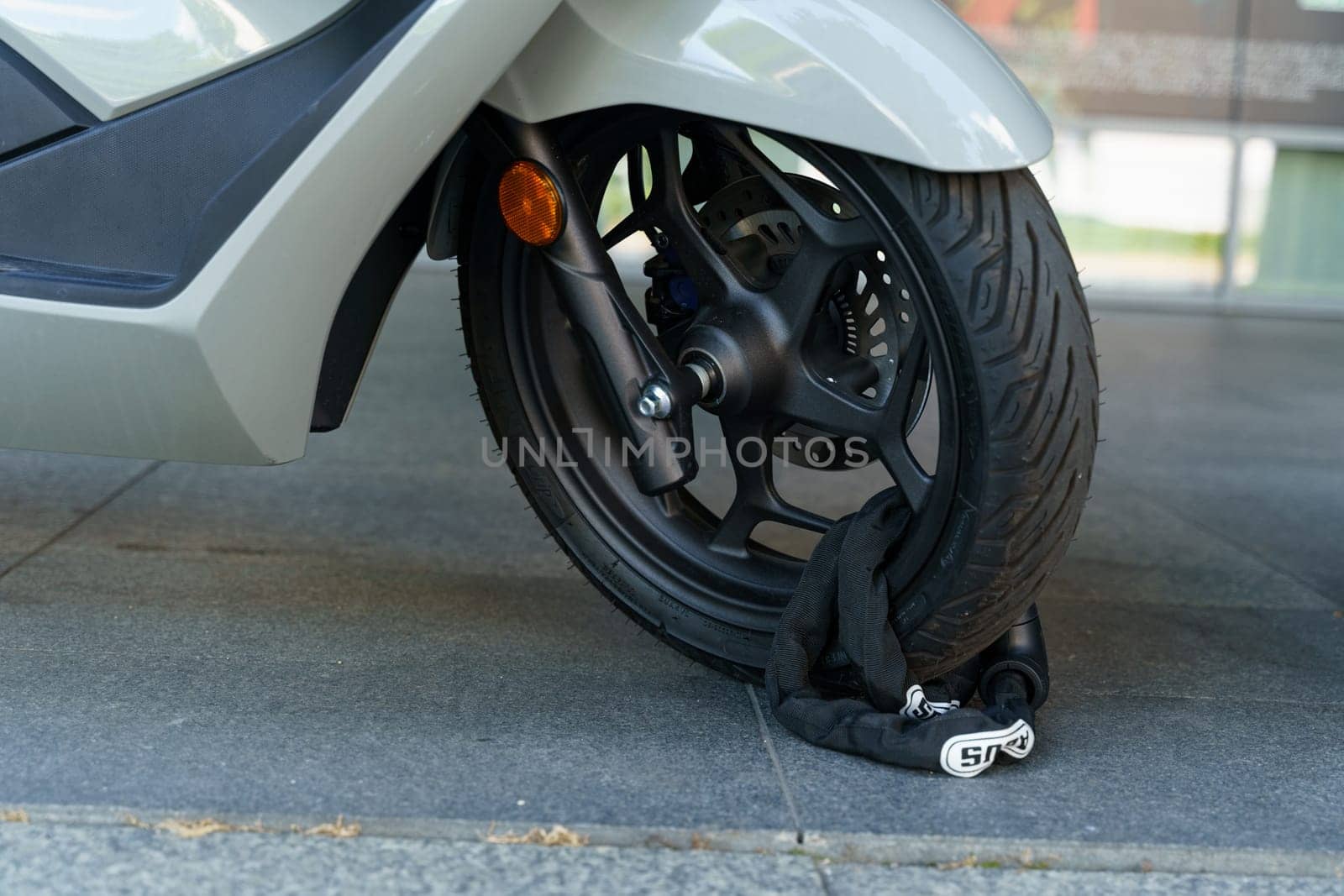 Wroclaw, Poland - August 4, 2023: A motorcycle attached to a tire with a lock, potentially for towing or transport purposes.