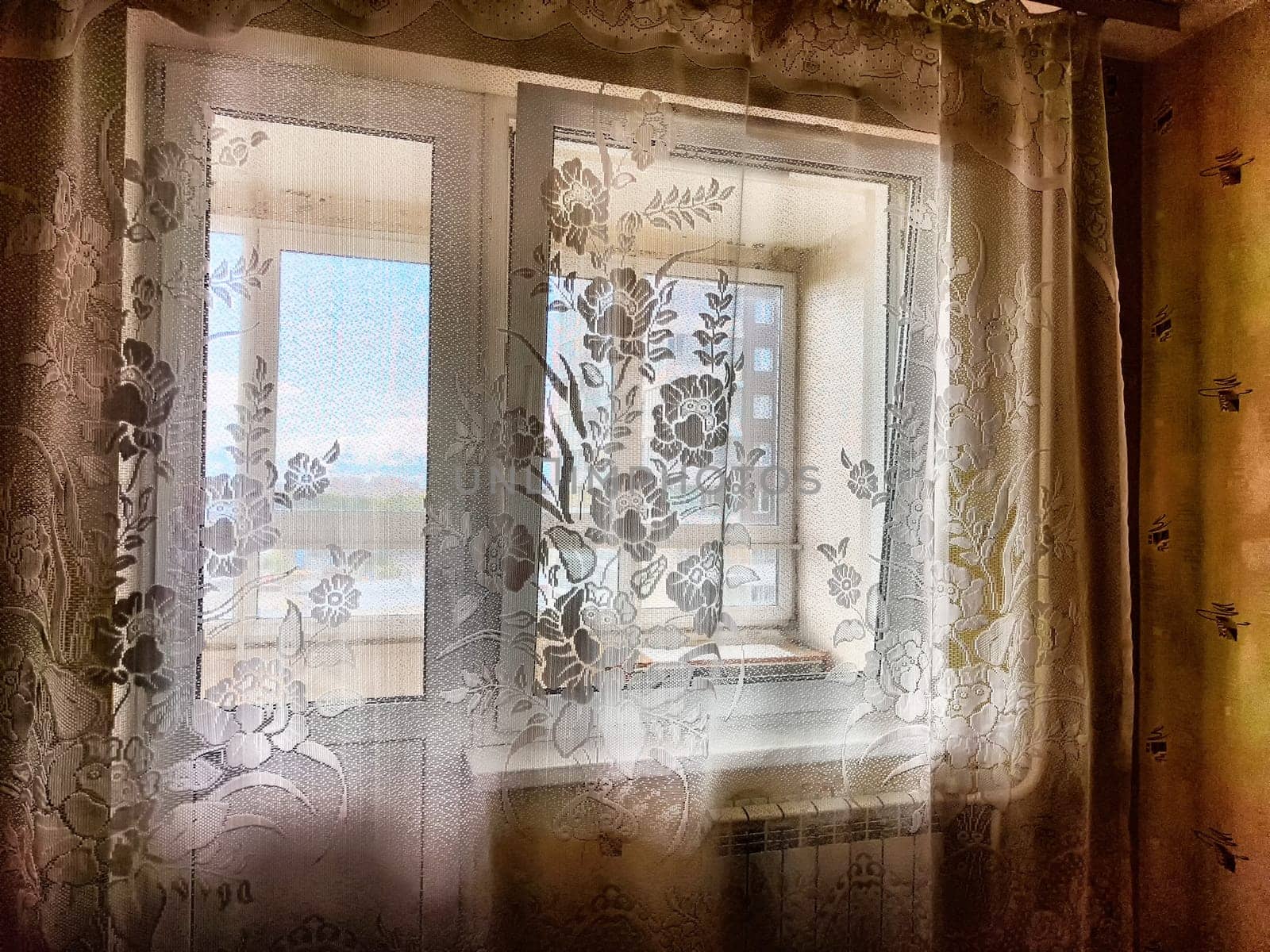 Morning Light Filtering Through Lace Curtains in a Cozy Room. Chiffon curtain on the window in the room by keleny