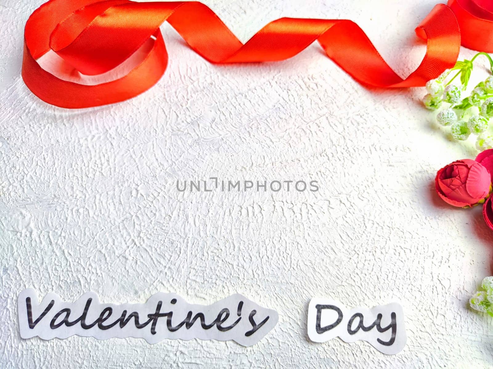 White background, flowers, red ribbon and Valentine's Day inscription. Concept of holiday. Card, Background, Texture, Frame, place for text, copy space by keleny