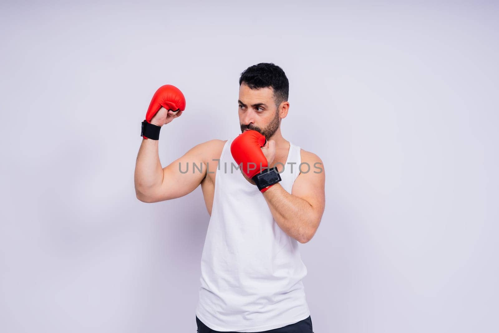 A man boxing with red gloves on his hands. Professional fighter, boxer. by Zelenin