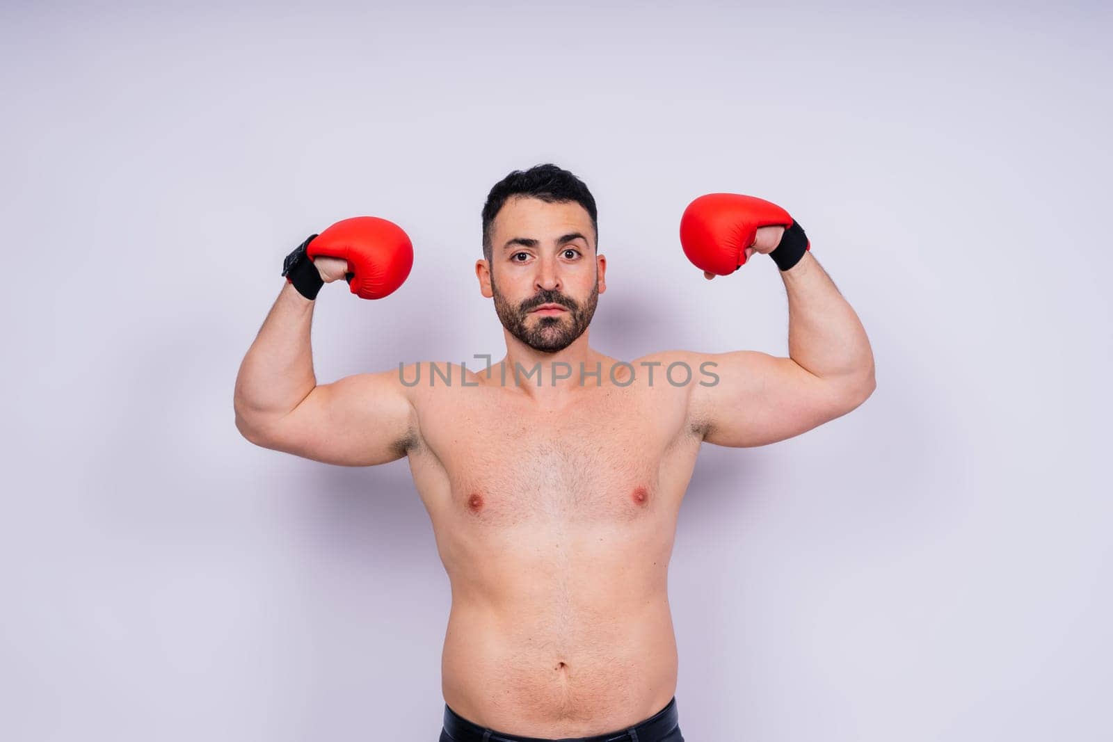 A man boxing with red gloves on his hands. Professional fighter, boxer. by Zelenin