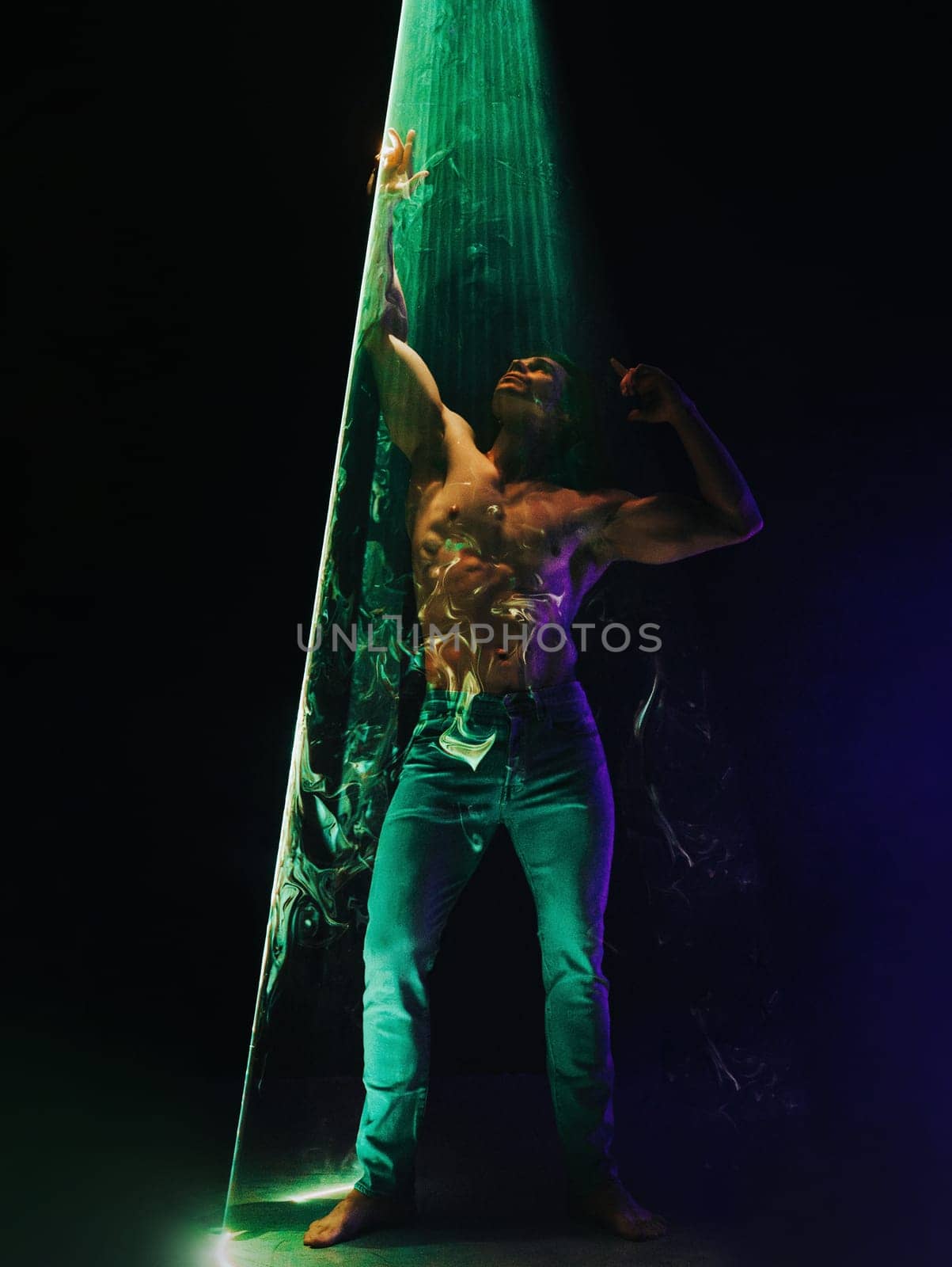 Sporty handsome muscular man portrait under colorful illumination, laser light by kristina_kokhanova