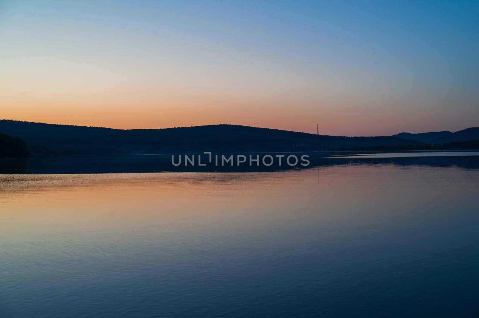 A calm and silent evening at sunset at the summer lake