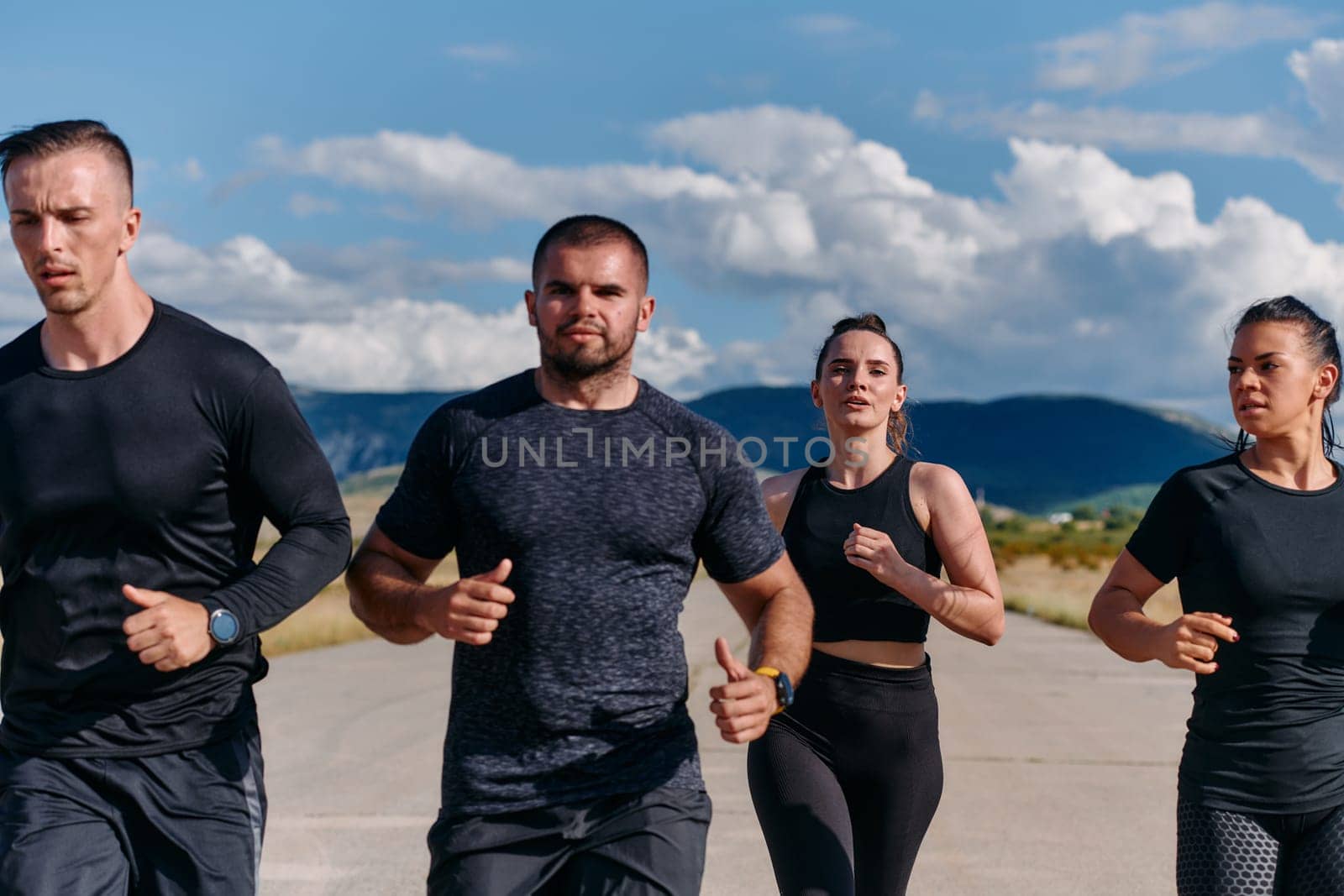 A professional athletic team as they train rigorously, running towards peak performance in preparation for an upcoming marathon.