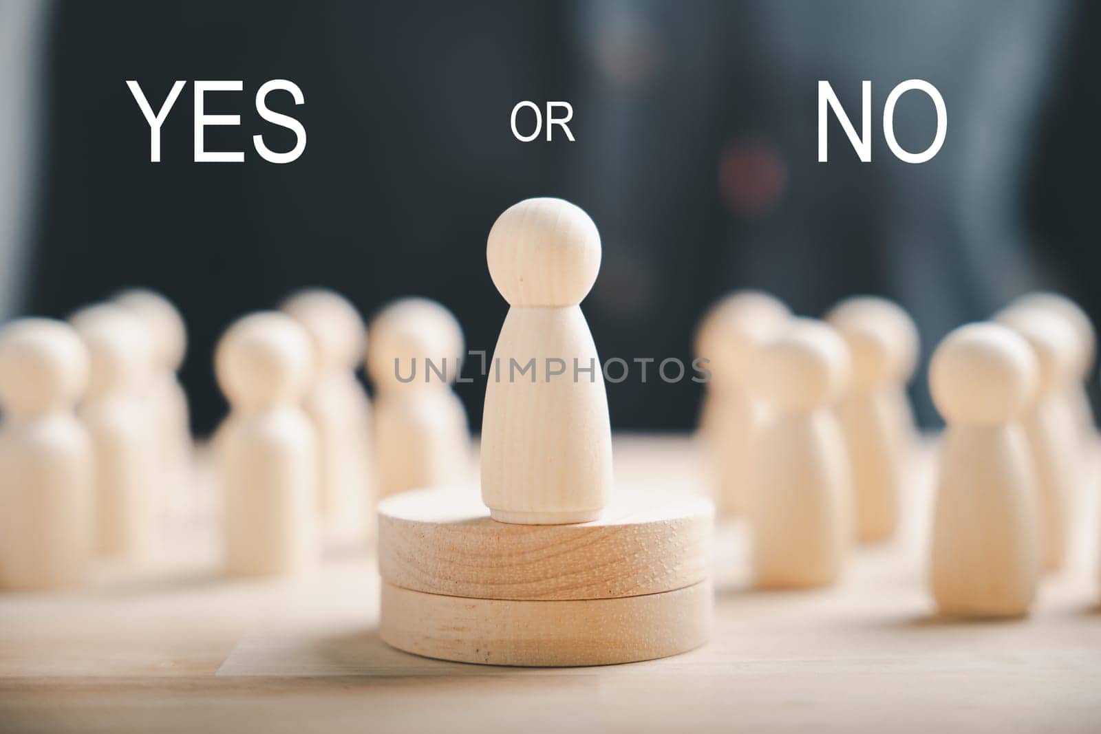 Wooden peg dolls positioned on a cube exhibit yes or no symbols. Embraces open-mindedness in elections with volunteers and candidates. Think With Yes Or No Choice. by Sorapop